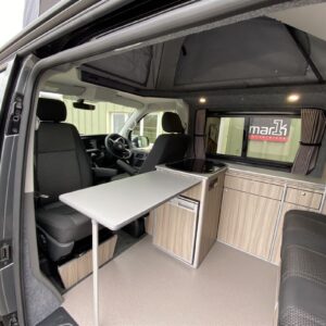2020.09 VW T6.1 SWB Conversion Inside View with Table in Front of Passenger Swivelled Seat