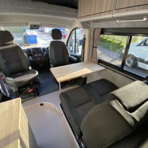 2021.03 Peugeot Boxer L4H2 Full Conversion View of Seating Area with Swivelled Front Seats and Table