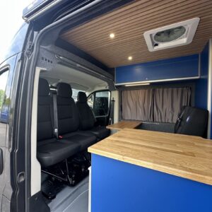 2025.06 Peugeot Boxer L3H2 Conversion Looking Through Open Sliding Door at Cab Seating Area